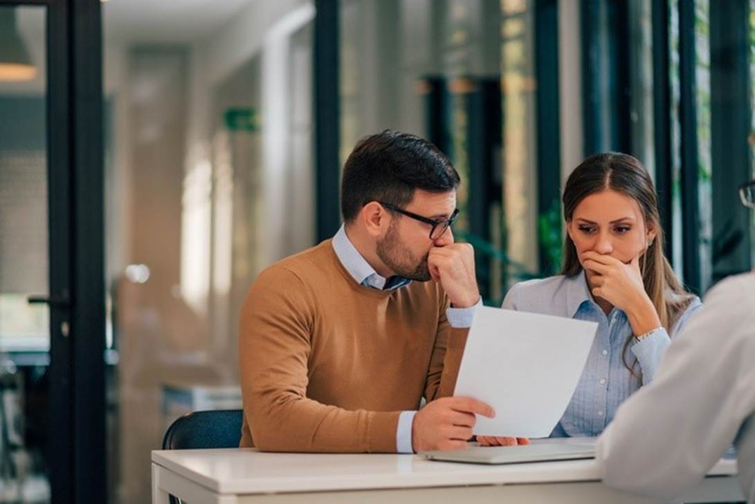 A person and person sitting at a table looking at a paper

AI-generated content may be incorrect.